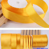 Roll of gold yellow satin ribbon for crafts and gift wrapping, showing the ribbon unwound.