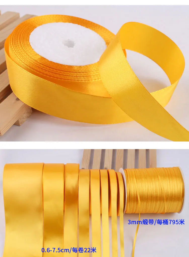 Roll of gold yellow satin ribbon for crafts and gift wrapping, showing the ribbon unwound.
