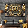 A large black banner featuring gold balloons and sparkling elements for a 50th birthday celebration displayed on a brick wall