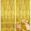 Two panels of vertical metallic gold foil fringe curtains used as party backdrops