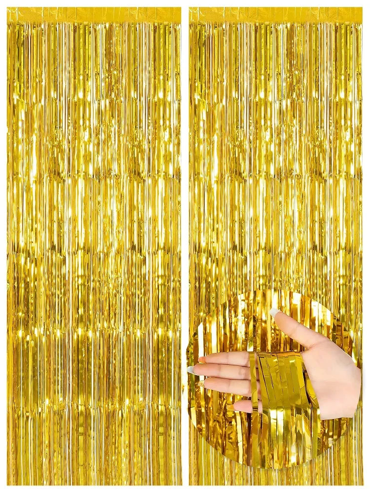 Two panels of vertical metallic gold foil fringe curtains used as party backdrops