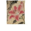 A wall tapestry featuring pink and white lilies on a muted beige background with dark accents.