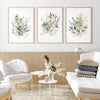 A set of three watercolor botanical prints featuring wild flowers and greenery on canvas wall art