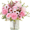 A bouquet of artificial silk roses and daisies in shades of pink, cream, and mauve.