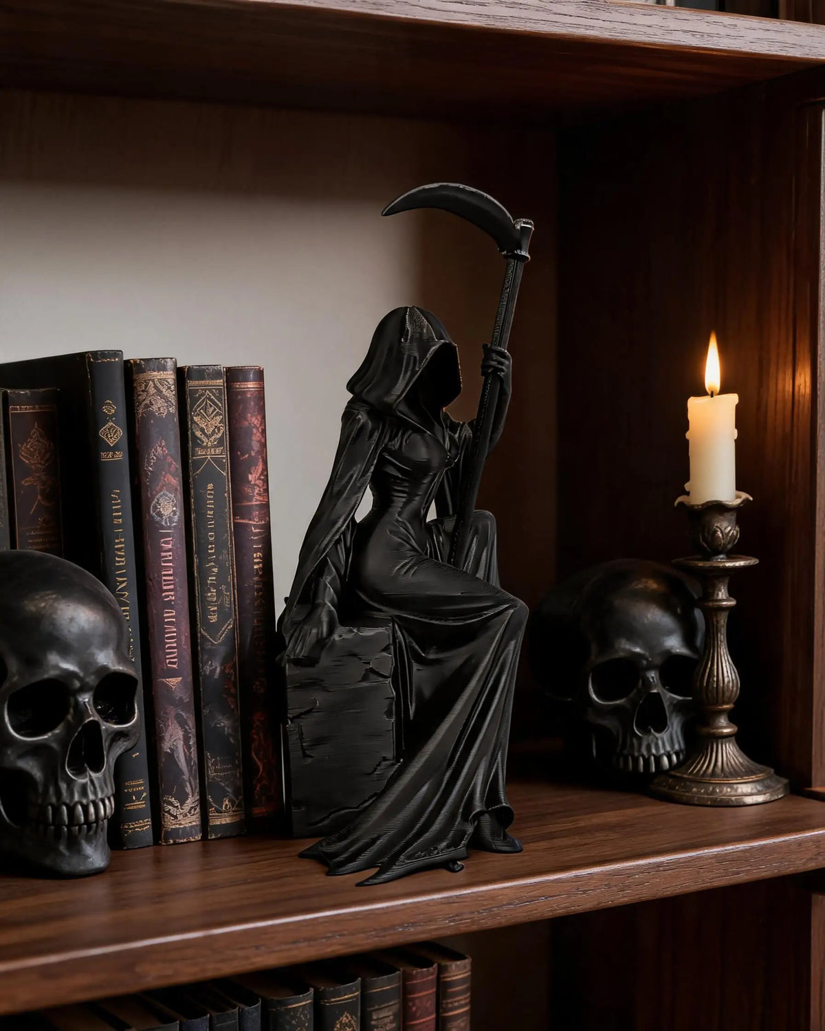 A black gothic female grim reaper figurine holding a scythe displayed on a wooden shelf.