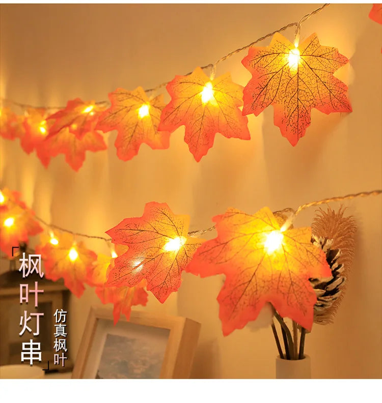 An autumn leaf garland with warm LED lights is displayed against a light background.