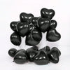 A cluster of black heart-shaped latex balloons for romantic celebrations.