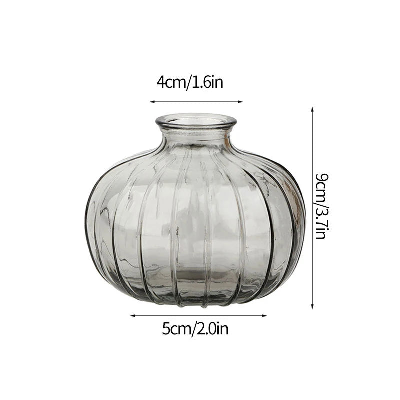 Modern clear glass vase with ribbed texture, measuring 4cm wide and 9cm tall.