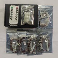 A kit containing various LED lighting components and a timer for building sets.