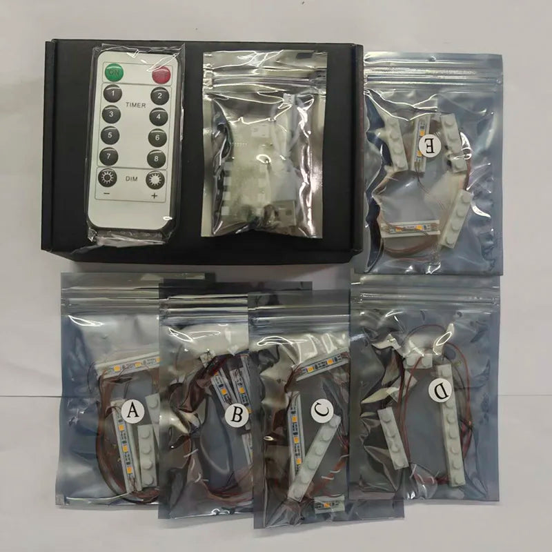 A kit containing various LED lighting components and a timer for building sets.