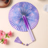 A purple and blue folding fan with a lavender tassel resting on a light background.