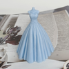 A light blue silicone mold shaped like a wedding dress, used for making candles or chocolate.