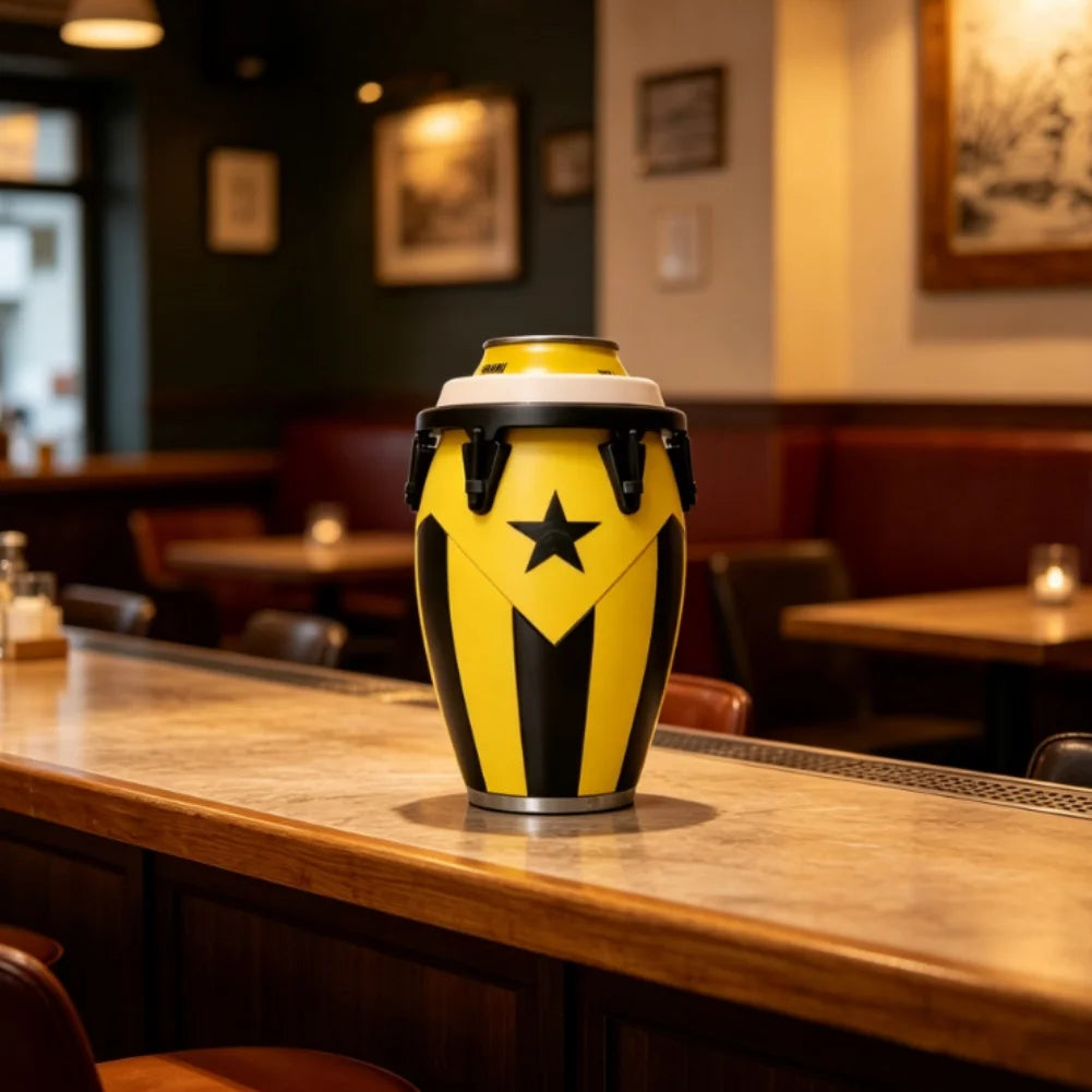A yellow and black drum-style can holder sits on a wooden bar counter in a dimly lit restaurant setting.