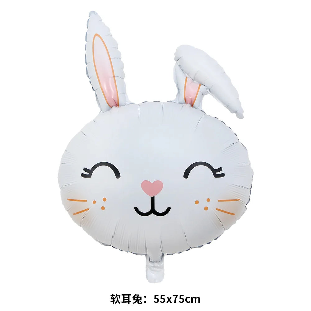 A white foil balloon shaped like a bunny face with long ears and a small pink heart on the cheek.