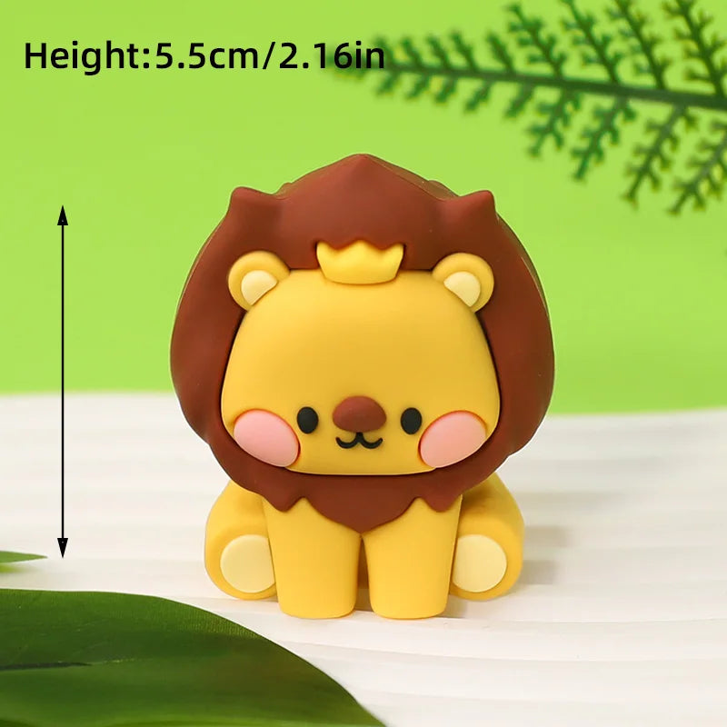 A yellow lion cake topper with brown mane and gold crown, shown against a green background.
