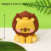 A yellow lion cake topper with brown mane and gold crown, shown against a green background.
