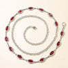 A silver waist chain featuring red crystal accents, displayed against a light background.