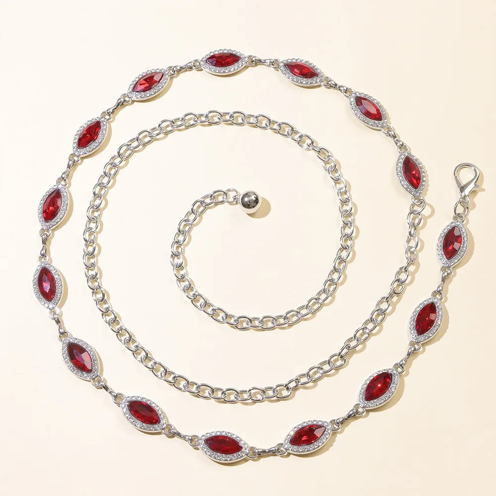 A silver waist chain featuring red crystal accents, displayed against a light background.