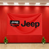 A red fabric banner featuring the Jeep logo in black on a wall.