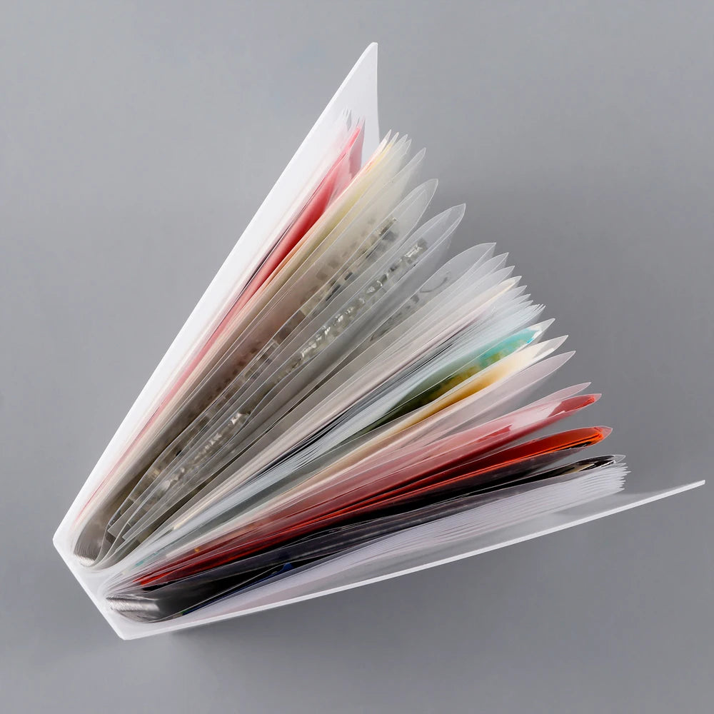 A clear A6 storage album with 40 pages for stickers, photos, and craft supplies, showing various colored pages.
