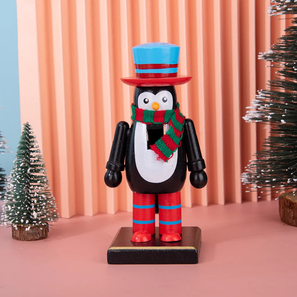 A wooden nutcracker soldier ornament with a blue top hat, black body, red boots, and a green scarf, displayed against a pink 