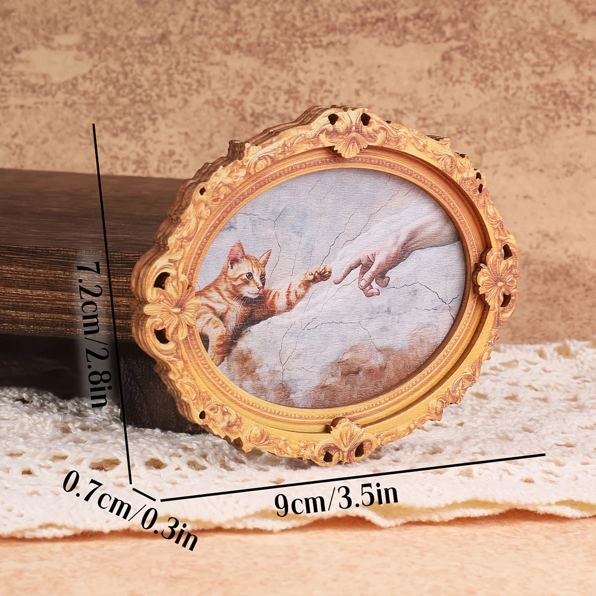 Vintage oval frame with a cat hand print inside, used as a fridge magnet decor.