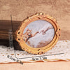 Vintage oval frame with a cat hand print inside, used as a fridge magnet decor.