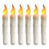 A set of five white taper candles with yellow flames, used for flameless LED candles.
