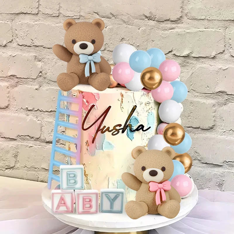 A tiered cake decorated with teddy bears and pastel balloons for a gender reveal party.