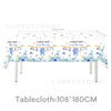 Tablecloth featuring a floral pattern with baby-themed sayings and decorative wooden accents for a baby shower.