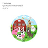 A circular plate decoration featuring farm animals like a pig, cow, and horse in front of a red barn and windmill.
