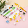 A collection of colorful silicone plant beads in various shapes and colors arranged on a pink background.
