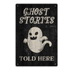 A dark wooden sign with white text that reads Ghost Stories and Told Here, featuring a white ghost graphic.
