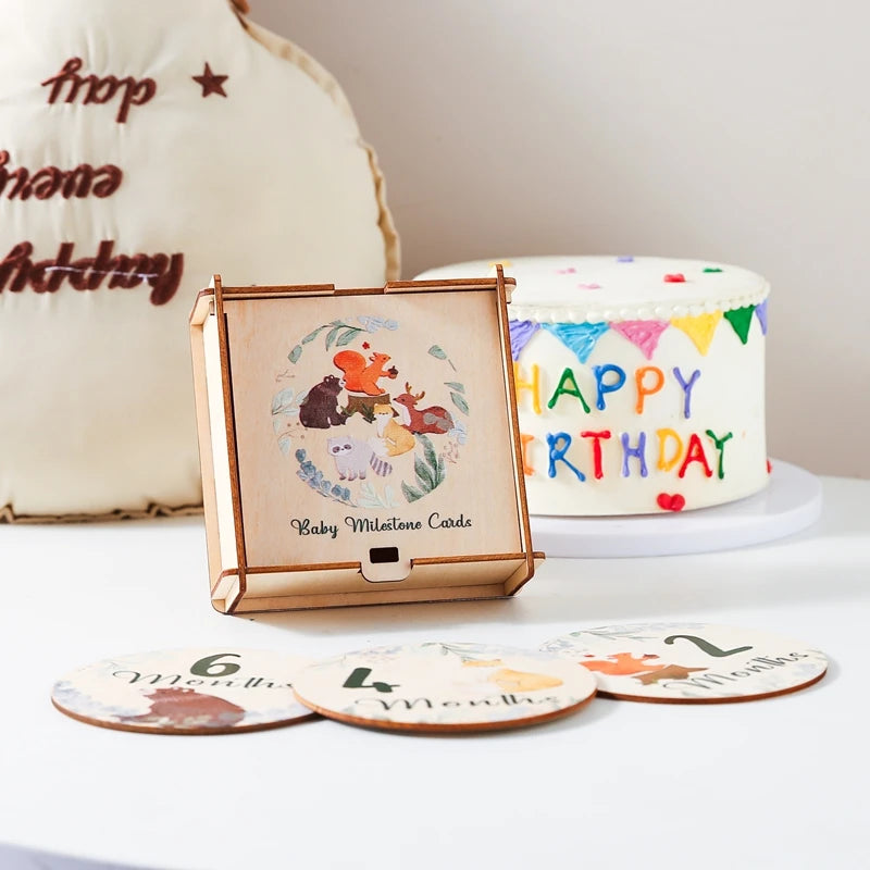 A wooden baby milestone cards set featuring a keepsake box and several round cards with monthly milestones.
