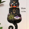 A black cat silhouette floating shelf featuring a moon, crystals, and decor for display.