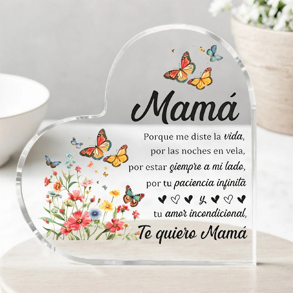 A clear heart-shaped ornament featuring floral designs and the text Mamá Porque me diste la vida por las noches en vela por e