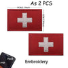 Two red embroidered medical cross patches with silver borders and hook loops