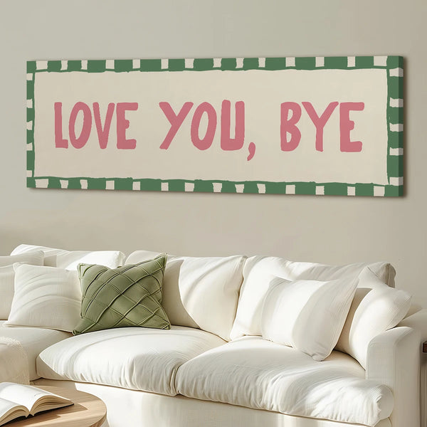 A framed canvas art print featuring the text LOVE YOU BYE in pink on a cream background with a green checkered border.