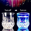 A clear glass party cup glowing with vibrant blue light, demonstrating the turn on function.