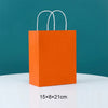 Orange paper gift bag with white handles, measuring 15x8x21 cm.