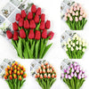 A collection of artificial tulip bouquets in various colors including red, pink, and white, presented in green foliage.