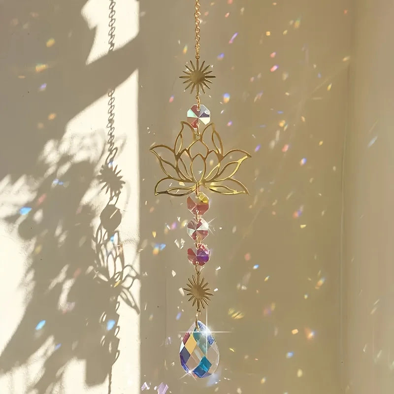 A hanging lotus flower crystal glass suncatcher with prism beads catching light in a bright room.
