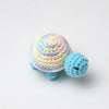 Handmade crocheted turtle plush toy with multicolored body and small dark eyes