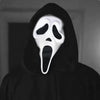 A realistic ghost face mask with a white, screaming expression is shown against a dark background.