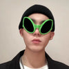 A close-up of a person wearing green alien sunglasses and a black beanie.