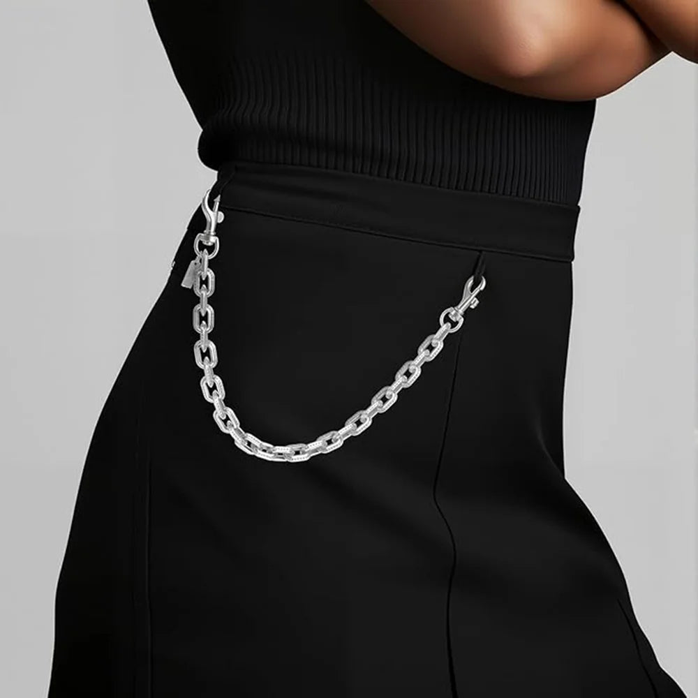 Silver paperclip chain bag strap worn on a black garment.