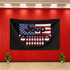 A black flag banner featuring the Jeep logo design with American flag elements mounted on a red wall.