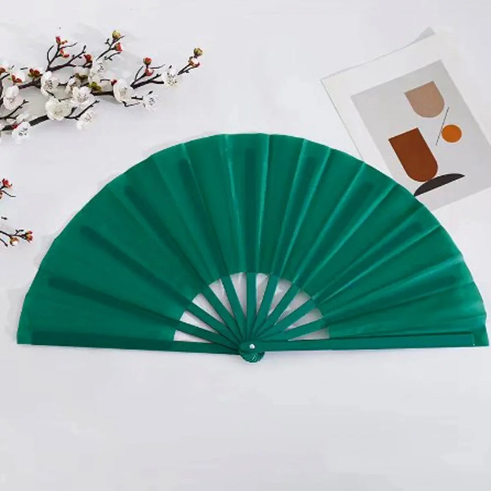A dark green Tai Chi performance fan with plastic ribs is displayed on a white background.