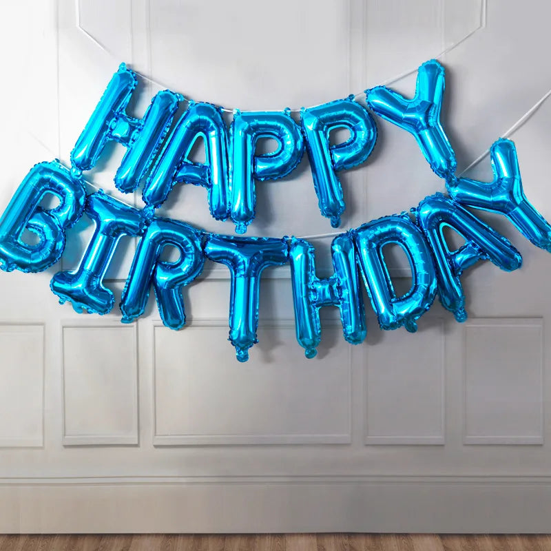 A garland of blue foil letter balloons spelling out HAPPY BIRTHDAY hanging on a white door.