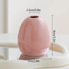 A pink ceramic mini vase is shown on a white surface with dimensions marked.